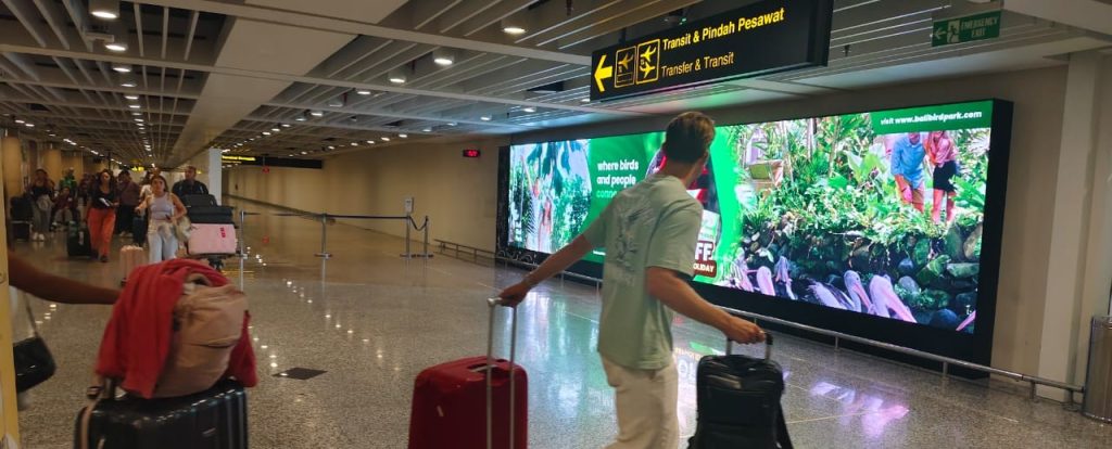 Bali Bird Park tourism advertisement on LED screen at I Gusti Ngurah Rai International Airport, Indonesia, 2025